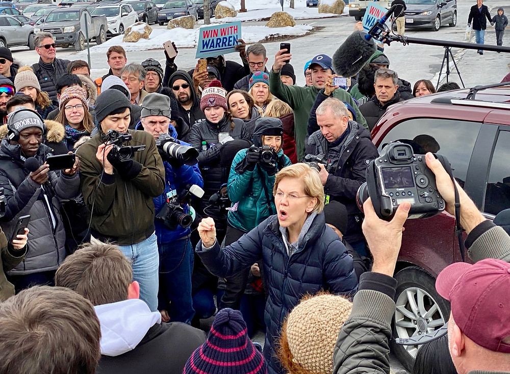 Elizabeth Warren talks to a crowd of overflow supporters at an event in Manchester, N.H.