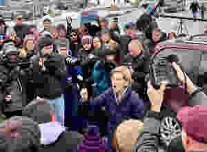 Elizabeth Warren talks to a crowd of overflow supporters at an event in Manchester, N.H.