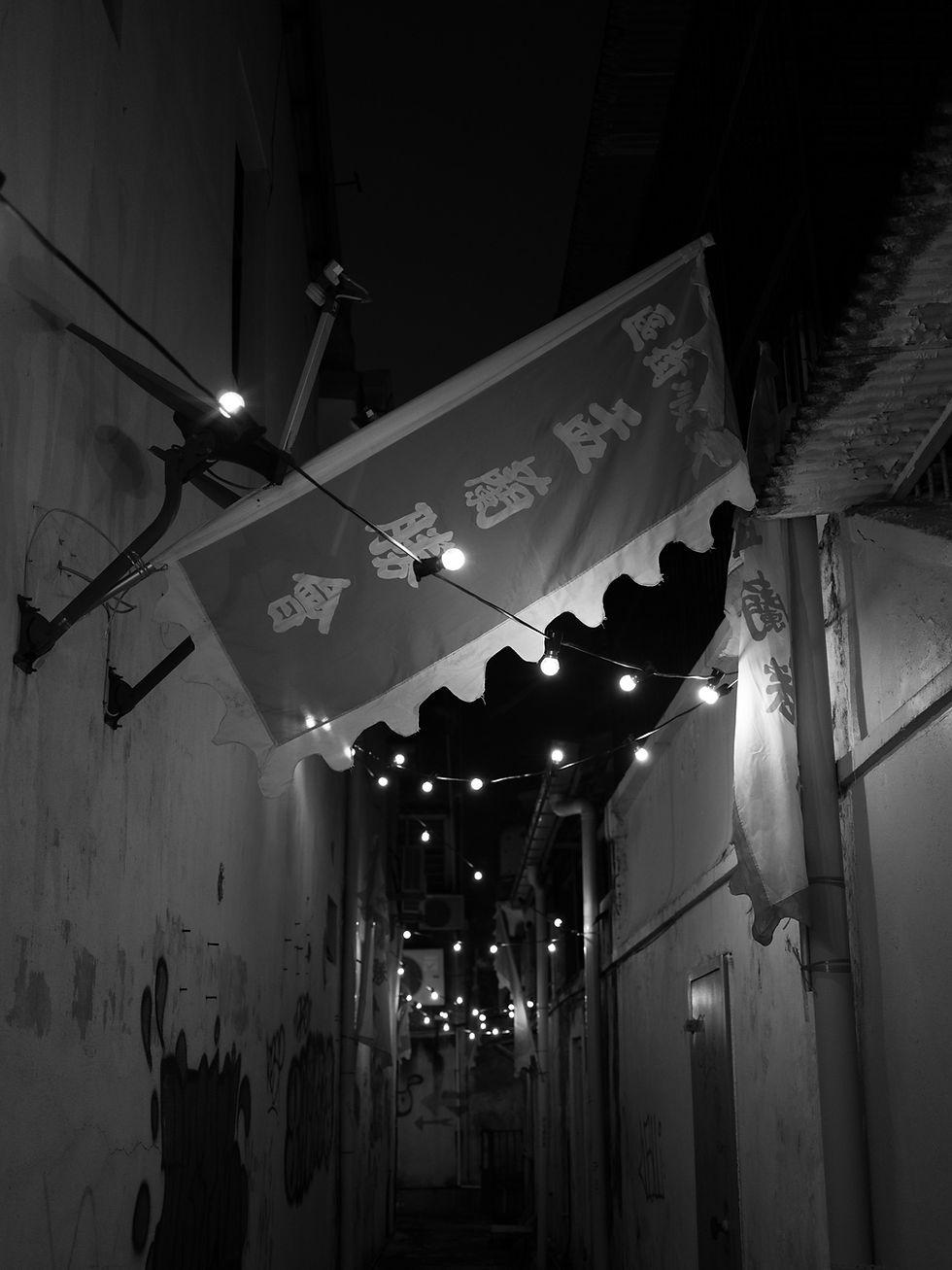 chinese prayer flag hanging on top of the alley