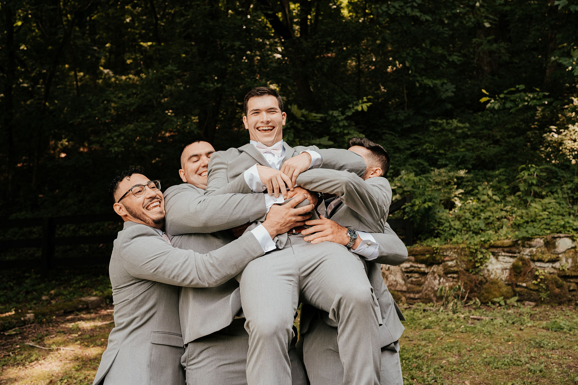 groomsmen celebrate groom