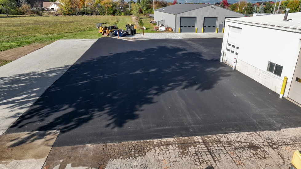 Aerial view of a newly paved commercial asphalt parking lot and expansion for an industrial building in East Troy, WI.