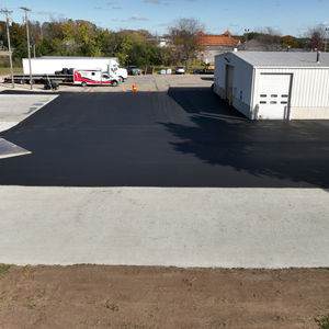 Aerial view of a newly paved commercial asphalt parking lot and expansion for an industrial building in East Troy, WI.