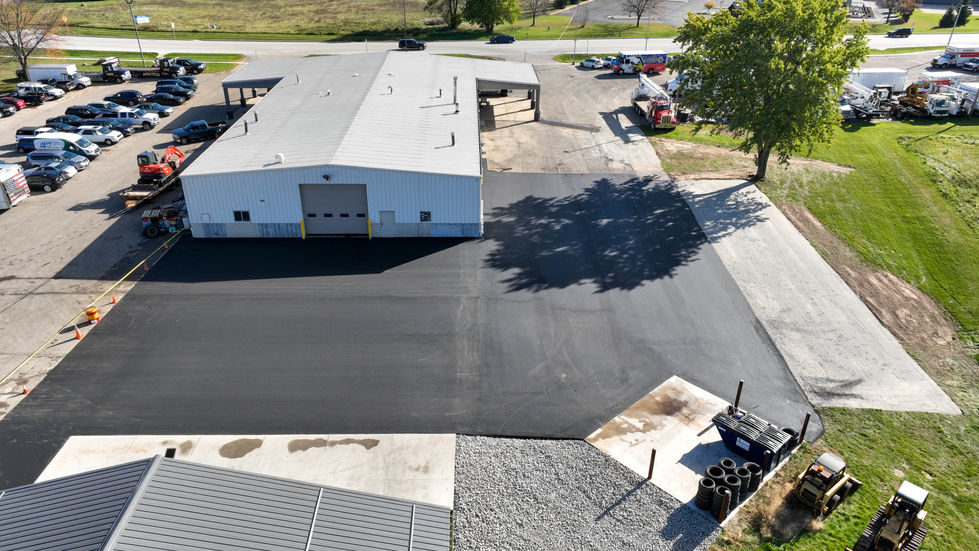 Aerial view of a newly paved commercial asphalt parking lot and expansion for an industrial building in East Troy, WI.
