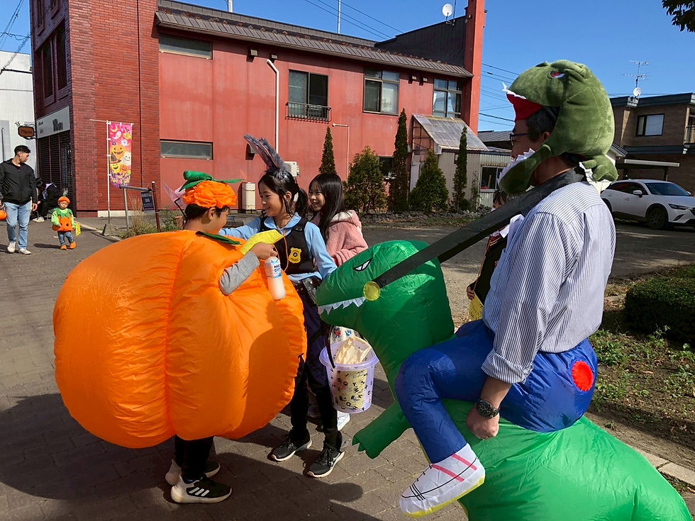 Families in Halloween costumes playing the stamp rally game at Urahoro Halloween in October.
