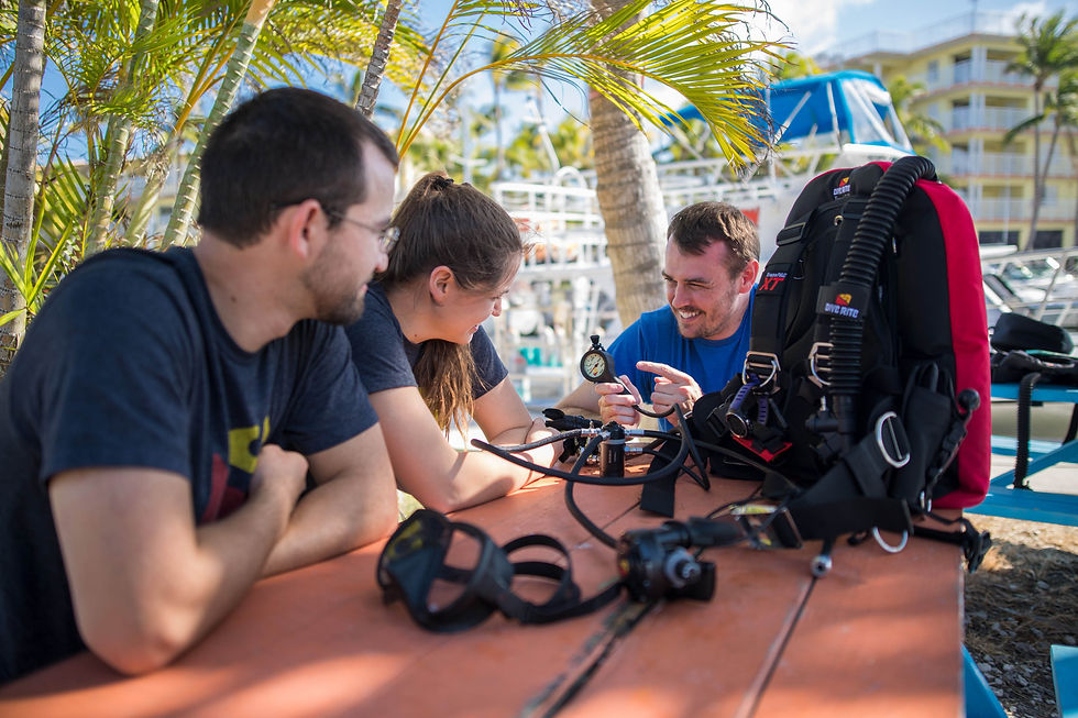 Eye-level view of scuba diving equipment laid out on a boat deck