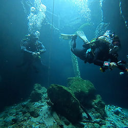 Divers descending into Paradise Springs.