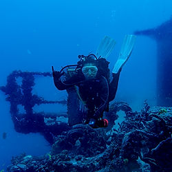 Diver hovering off the bridge wing of the USS SPiegel Grove