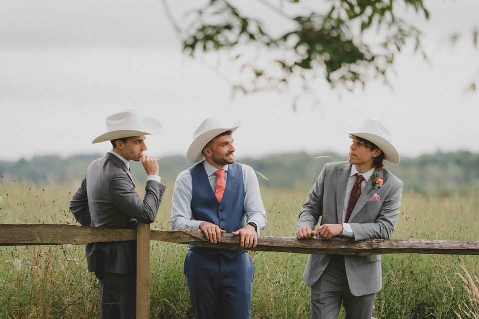 Groom Joe poses with his 2 brothers and groomsmen after they presented him with his very own Stetson hat during their wedding speech