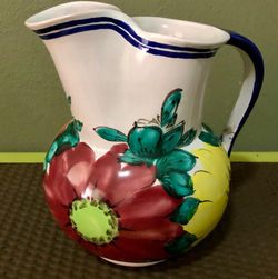 Red and yellow floral clay pitcher