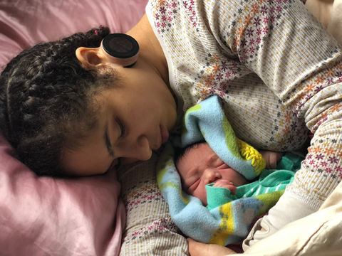 birthing parent and newborn resting together