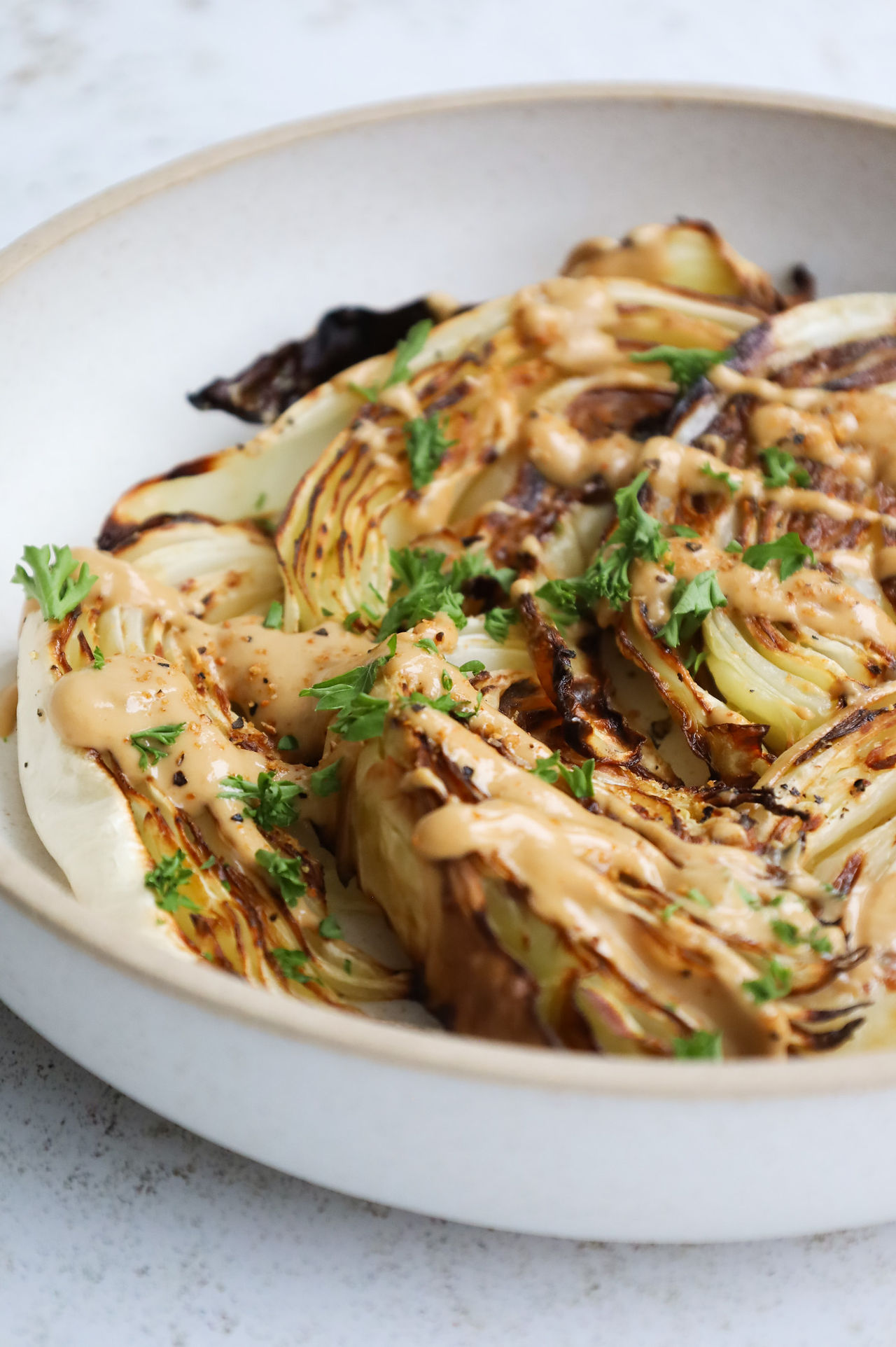 Oven-roasted cabbage wedges with a miso tahini dressing