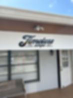 Storefront featuring a sign that reads "Timeless Amps," showcasing a music equipment shop.