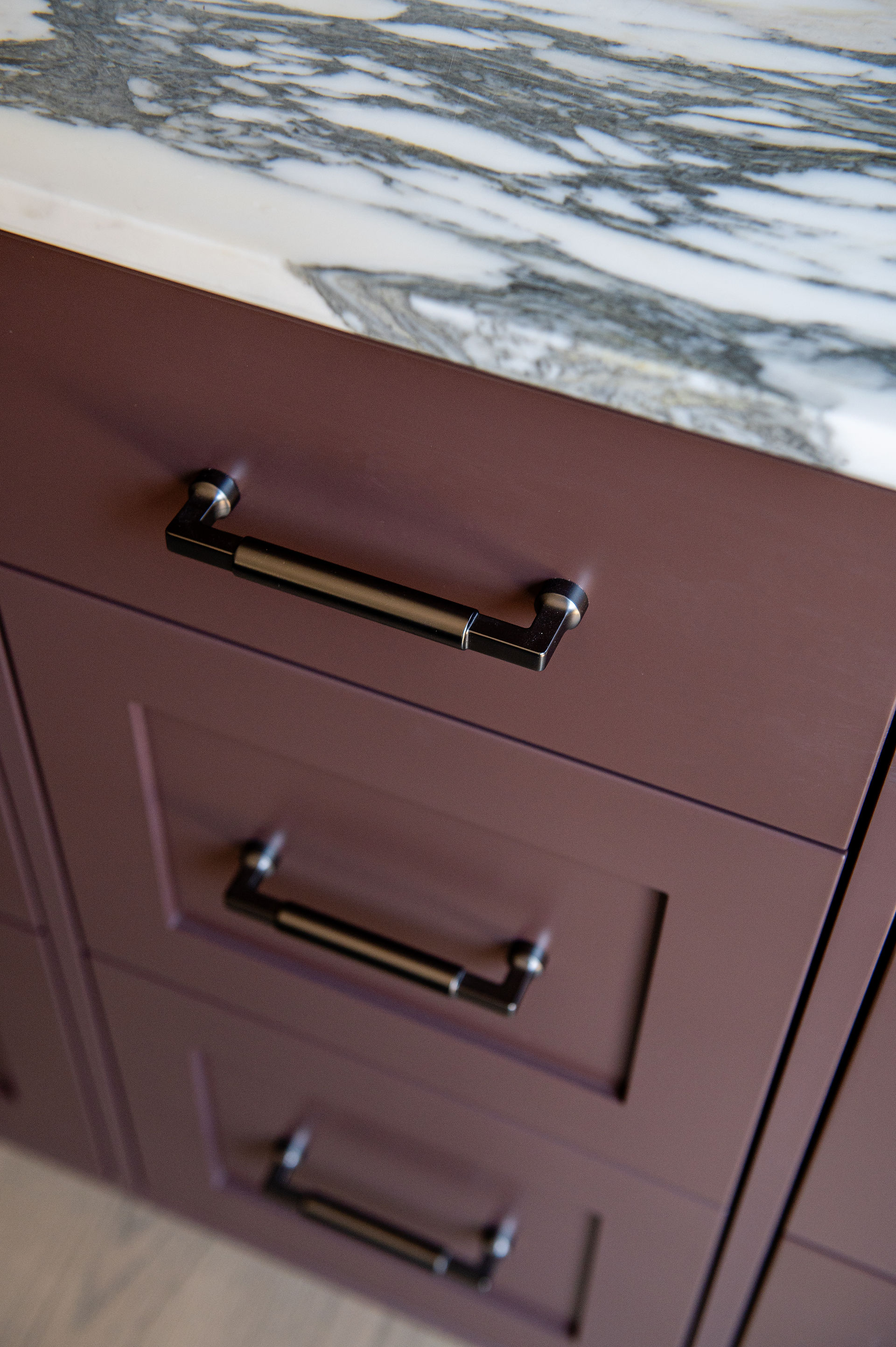 close-up of mauve cabinetry with oil rubbed bronze bar pulls