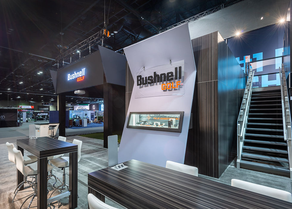 Eye-level view of an unbranded exhibit walkway leading toward a hands-on product display.