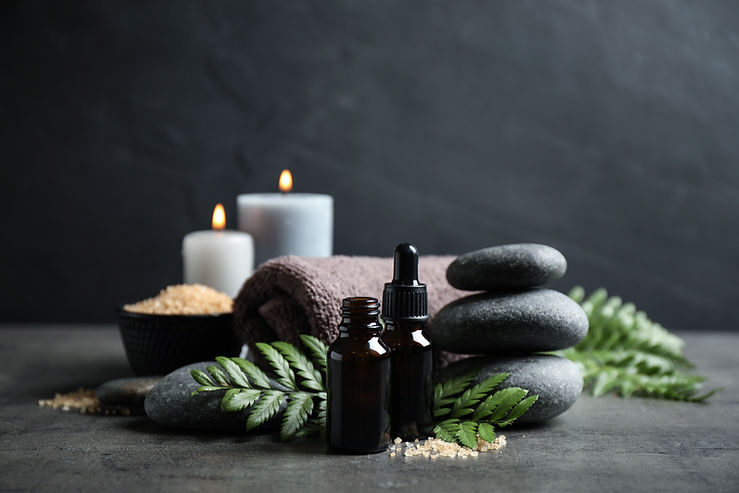 Spa composition with aroma oil on grey table.jpg