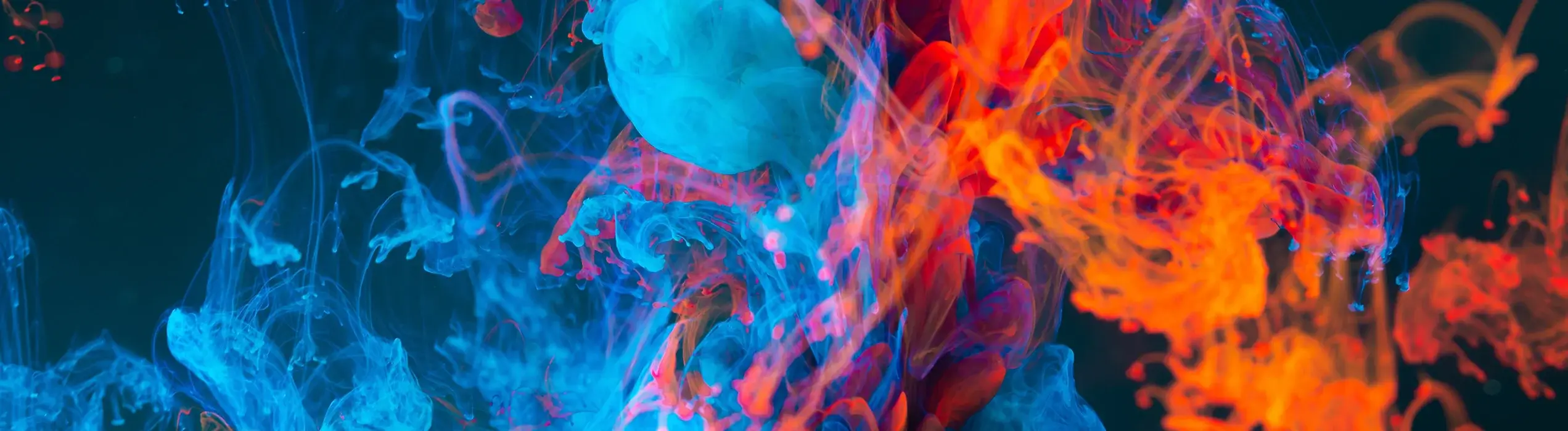 Image of speratic and decorative blue and orange smoke clouds on a dark background