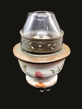 an old Opium Lamp on a black background displayed in the museum of drugs