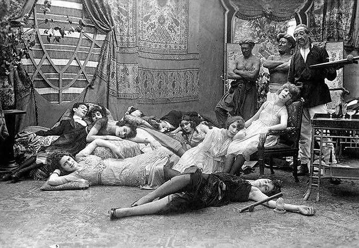 Black and white picture of men and women lying on the floor under the impression of drugs