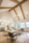 Living room with high valuted ceiling with wood beams Preserve Custom Homes