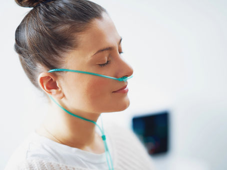 woman gently smiling with cannula in nose