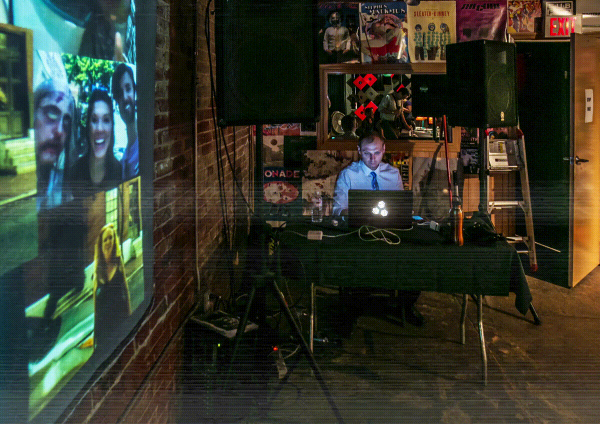 humorous gif showing Institute for Psychogeographic Adventure co-founder Radek sitting at a glowing computer as part of a performance with animated static like an old television set, as a visual intro to the contact page.