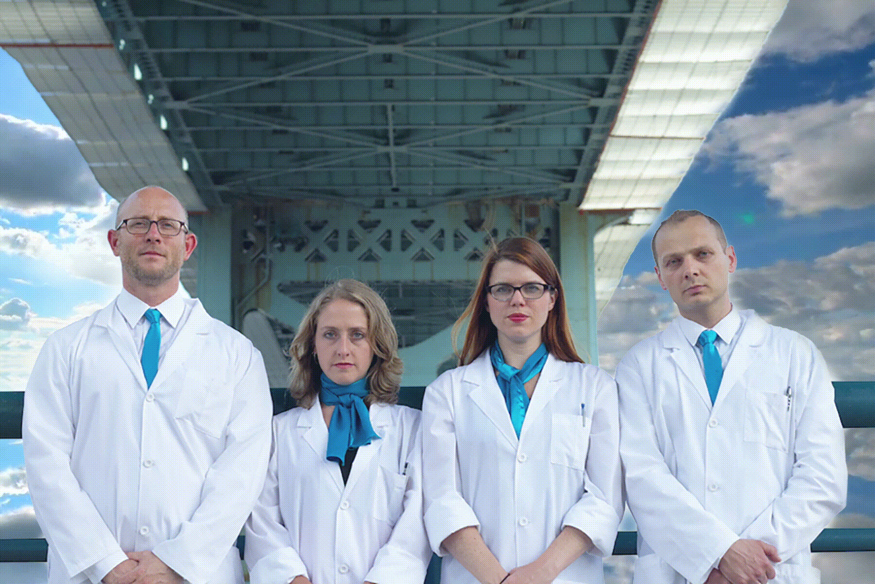 humorous gif if the theater company's co-founders in lab coats under a bridge with animated clouds behind them.