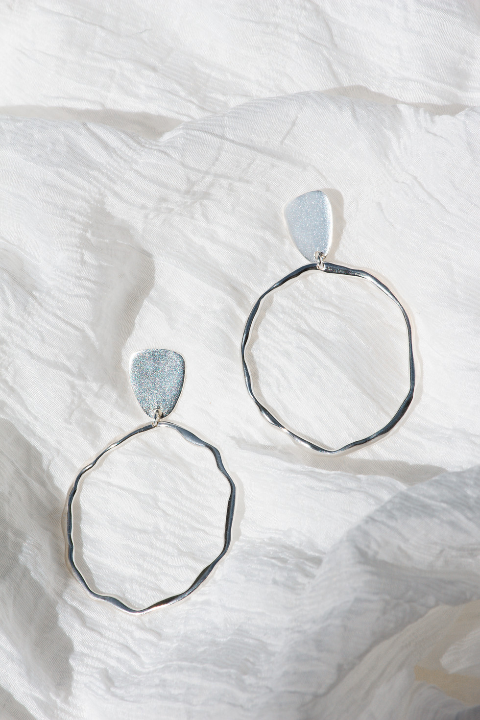 Organic textured drop earrings in sterling silver with irregular sculptural hoop