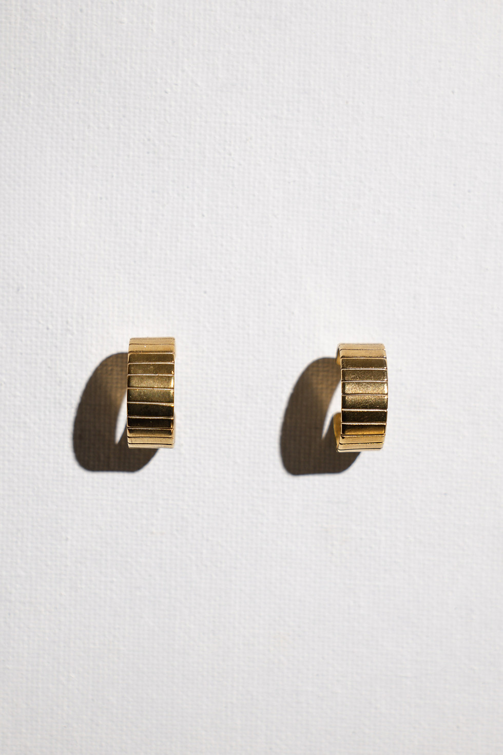 Textured gold hoop earrings with hand engraved detail