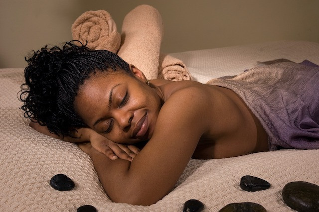 A black woman relaxed and waiting for her massage.