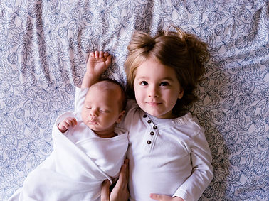 Siblings on Bed