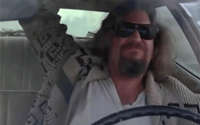 An image from the 1998 movie, "The Big Lebowski" of The Dude rocking out in a car