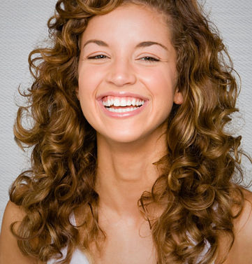 Adding layers to curly hair can help define curls and reduce bulk. It also allows for a more manageable and styled look.