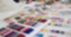 stock-photo-colorful-fabric-and-thread-catalog-on-seamstress-or-dressmaker-work-table-back