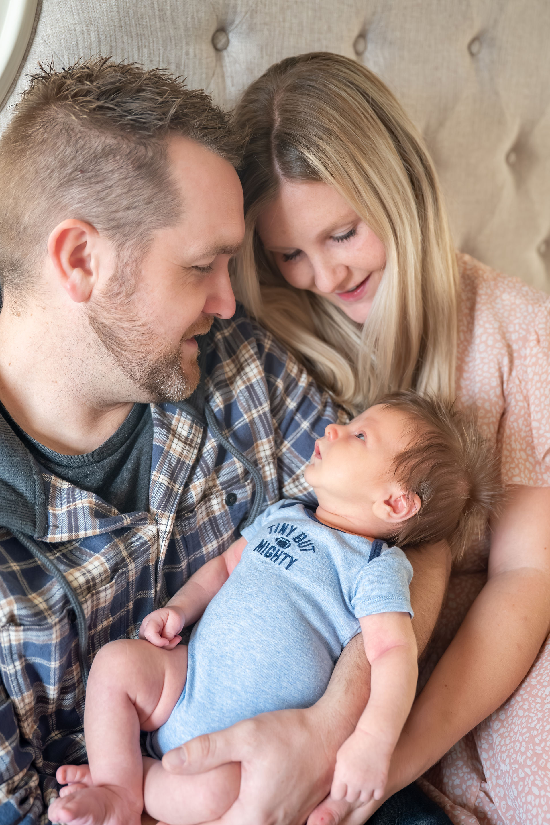 Parents admiring their newborn baby