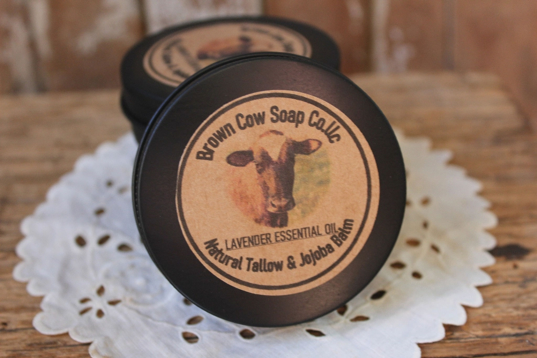 round tin of tallow balm with jojoba oil with brown cow soap company label