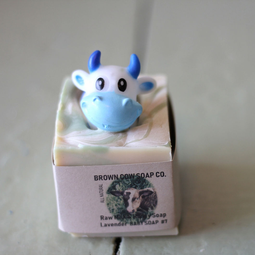 Thumbnail: a cute blue cow shaped bath toy in a bar of natural handmade soap