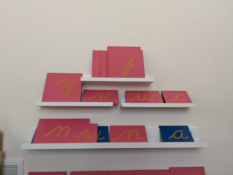 Image of colorful Montessori sandpaper letters, providing a sensory-rich learning experience for young students to develop their language skills.
