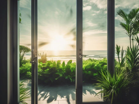 A sunlit double door opens to a lush garden and ocean view, symbolising how exit planning creates freedom, future choices, and a business that serves your life.