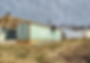 Construction of a produce storage space using shipping containers, showcasing innovative commercial contracting techniques.