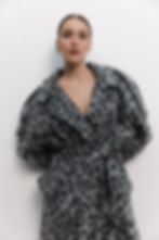 Close-up of animal print fabric texture on Mirgorod Trench Coat by WeHeat - premium wool material