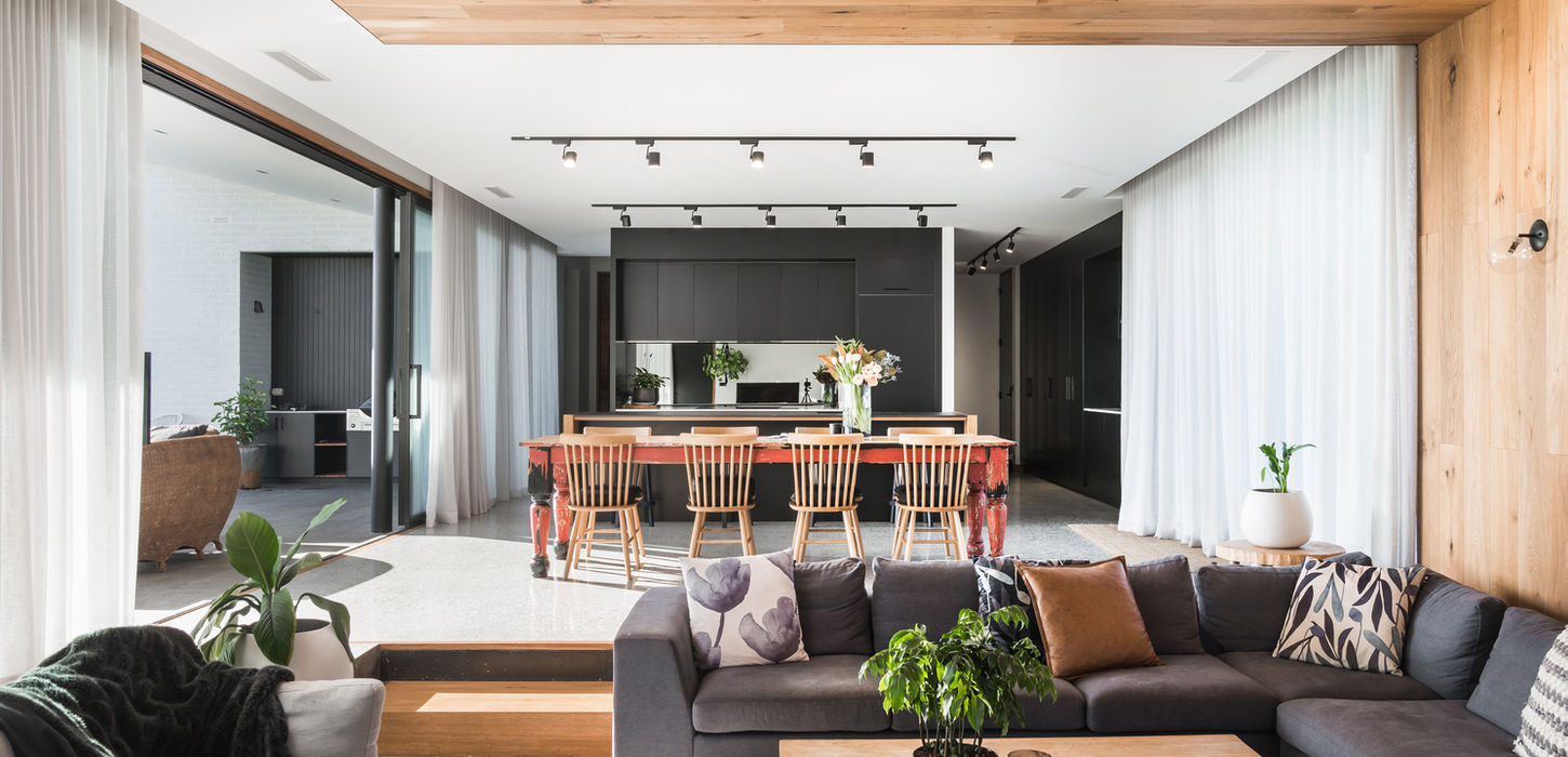 Interior sunken lounge at Ivy Lane Residence, featuring polished concrete floors and custom timber seating, reflecting eco-conscious design in Launceston