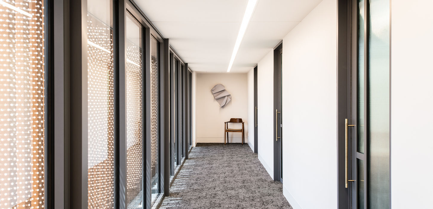Interior corridor of Dr Daniel Tan and Associates clinic with minimalist design and efficient layout