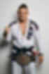 Owner and head instructor Anton Berzin wearing jiu-jitsu gi with black belt and CFFC championship belt.