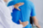 Male doctor therapist doing healing treatment on man's back.Back pain patient, treatment, 
