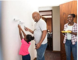 Happy family painting a room. Credit: Pixel Catchers by Getty Images Signature on Canva Pro