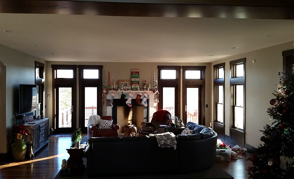 A room with white walls and thick dark wood trim around and under the windows. Photo credit: Barb Bickford