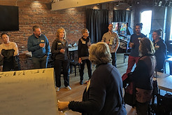 A group of people standing and discussing something