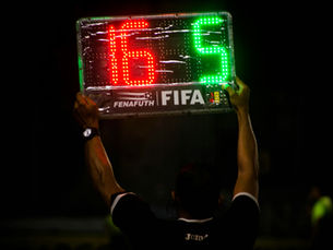 Man holding FIFA soccer game scoreboard