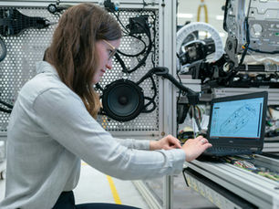 Female electronics engineer runs vehicle tests.