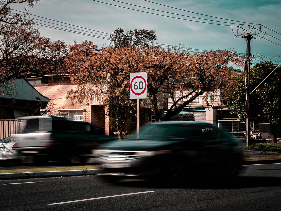 car speeding past a speed limit sign